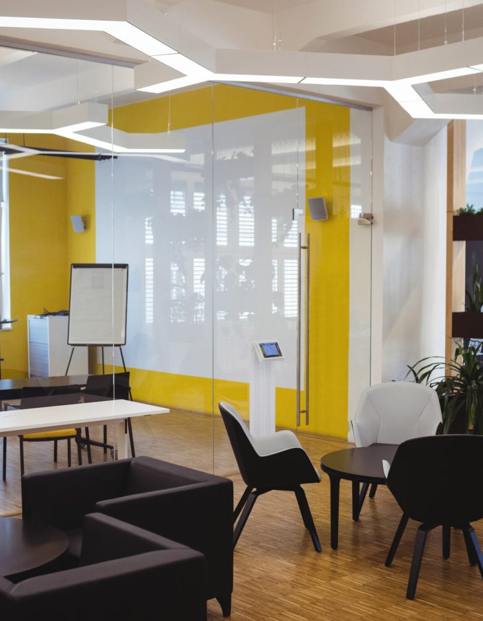 View of empty modern office with sofa, table, chair